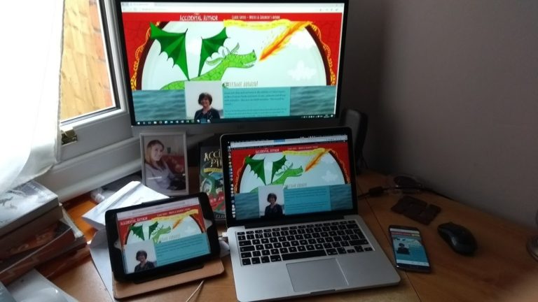 My desk with a desktop PC, Macbook, iPad and Android phone, all showing Claire's website.
